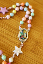 Load image into Gallery viewer, This colorful centerpiece depicts Our Lady of Lourdes visiting sweet Saint Bernadette.