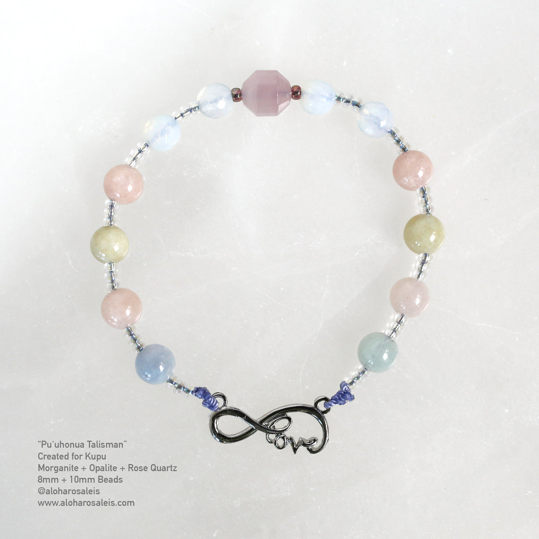 Kupuʻs Puʻuhonua Talisman, July 2021, features the gentle semi precious gemstones of Morganite, Opalite and Rose Quartz. 